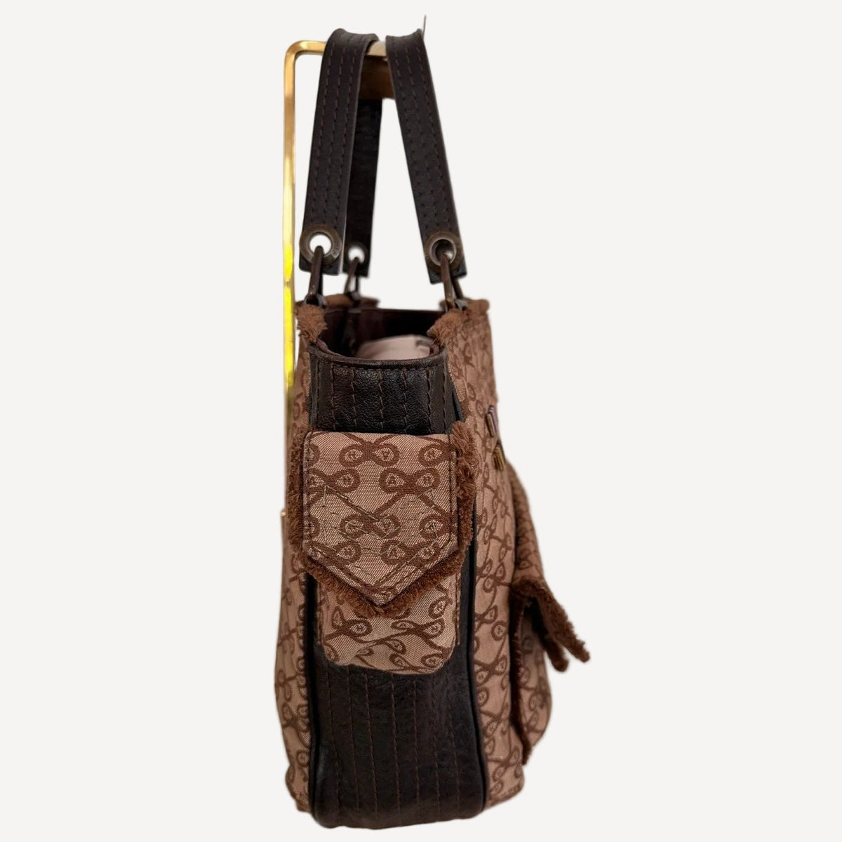 Brown patterned handbag with black accents on a white background