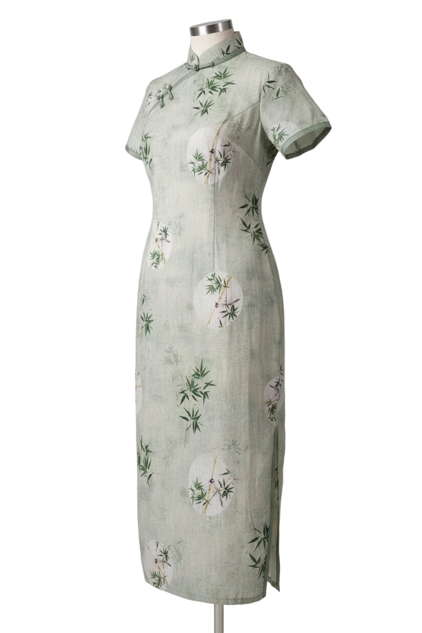 Light green dress with floral and bamboo patterns on a white background